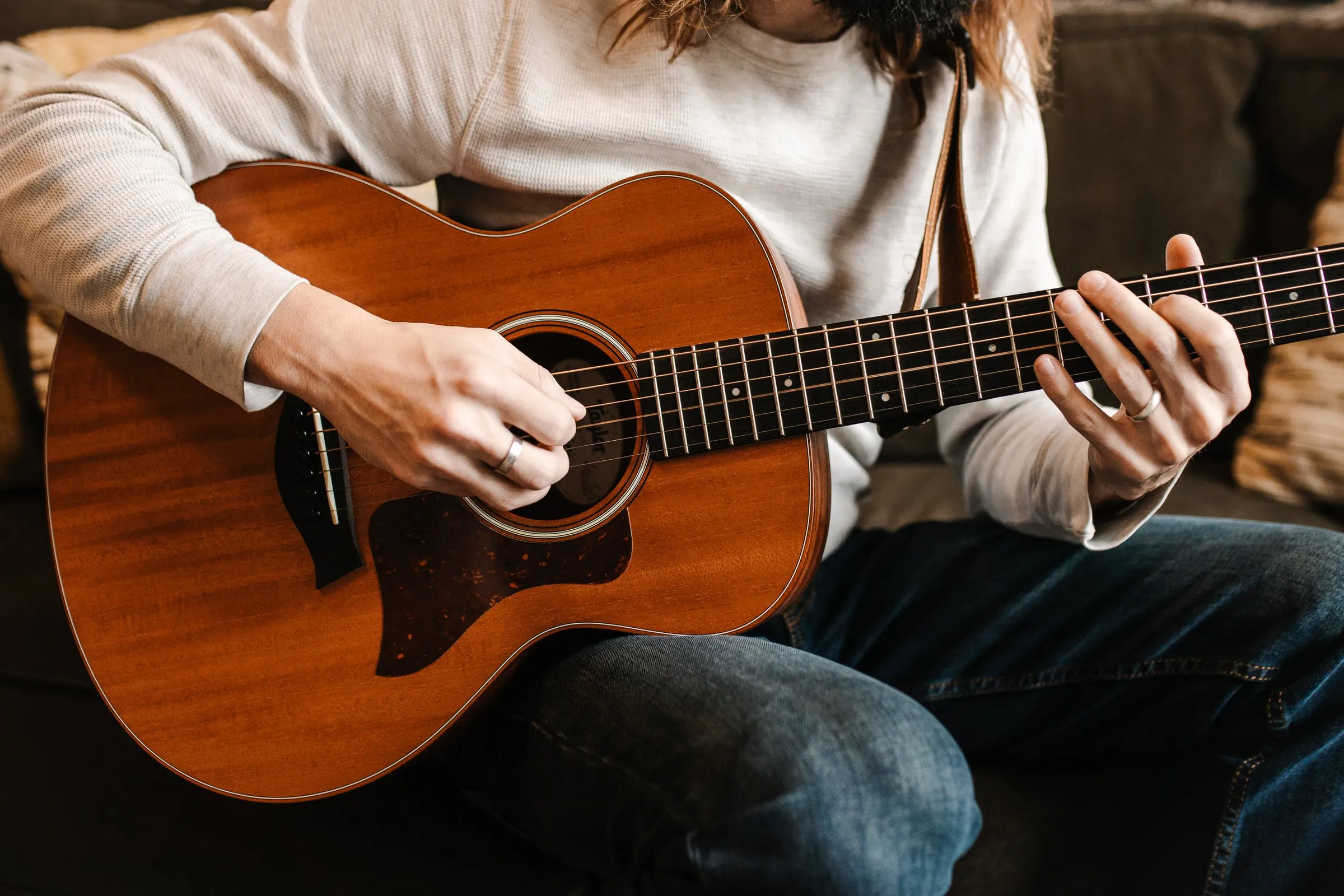 Close-up of hands playing an acoustic guitar